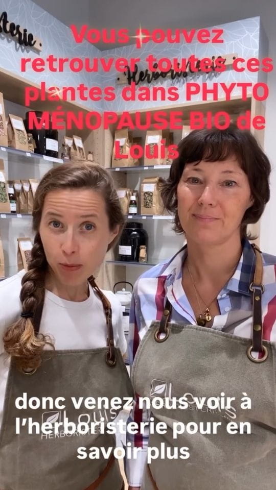 Deux femmes en tablier Louis Herboristerie devant des étagères de plantes, avec le texte Vous pouvez retrouver toutes ces plantes dans PHYTO MÉNOPAUSE BIO de Louis et la mention donc venez nous voir à l'herboristerie pour en savoir plus.